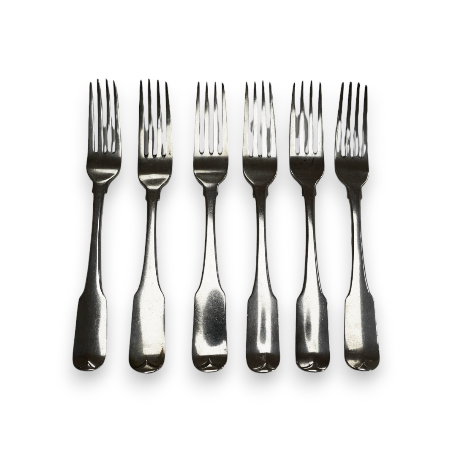 A set of four George III Irish silver fiddle pattern table forks, maker JS, Dublin, 1804, 20.9cm and a similar later pair, 12.8oz. Condition - poor to fair